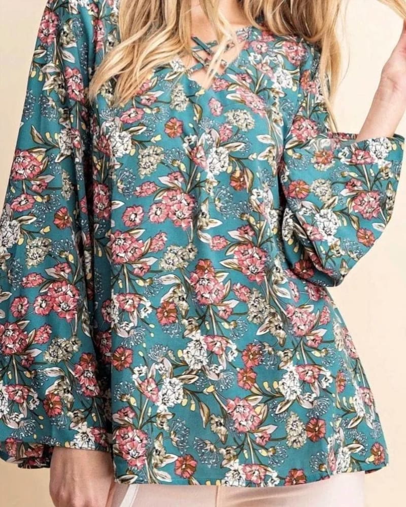 Front of a model wearing a size L Floral Criss-Cross Top in Green in Green by KORI. | dia_product_style_image_id:333473